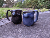 Female form, black glaze Mug